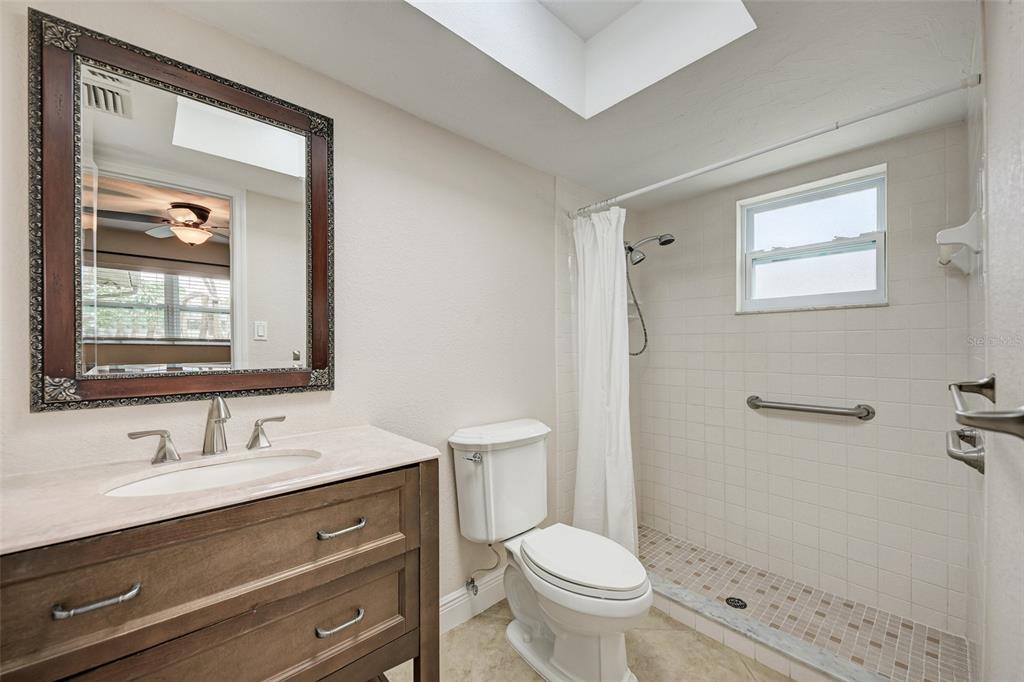 1330 Georgetowne Circle Sarasota, FL 34232 - Photo 26 of 46 a bathroom with a sink a toilet a mirror and shower