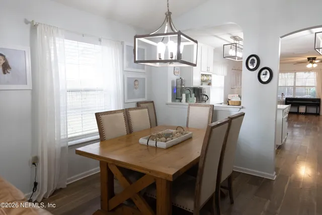 a view of a dining room with furniture window and wooden floor