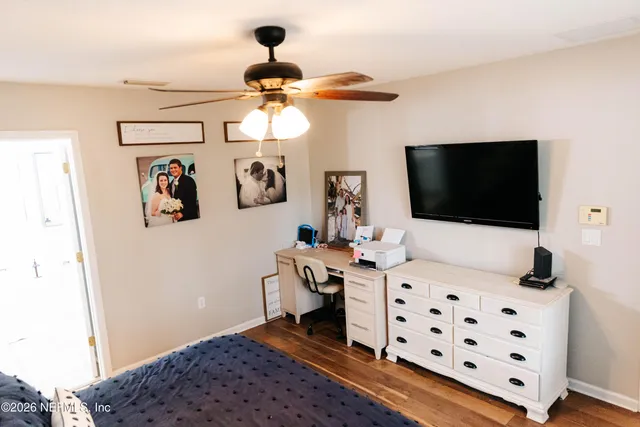 a view of a workspace with furniture and a flat screen tv