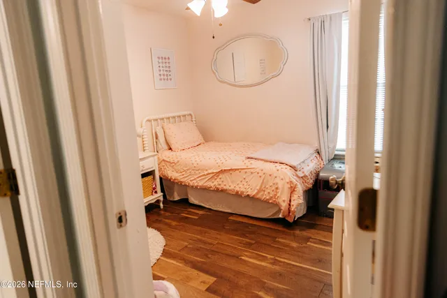 a bedroom with a bed and a book shelf