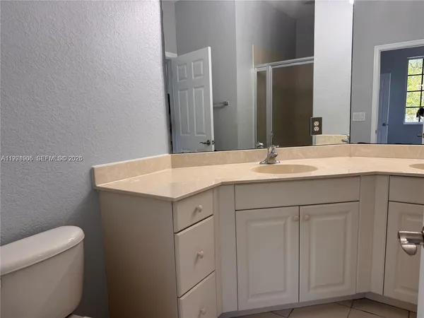 a bathroom with a sink vanity and a mirror