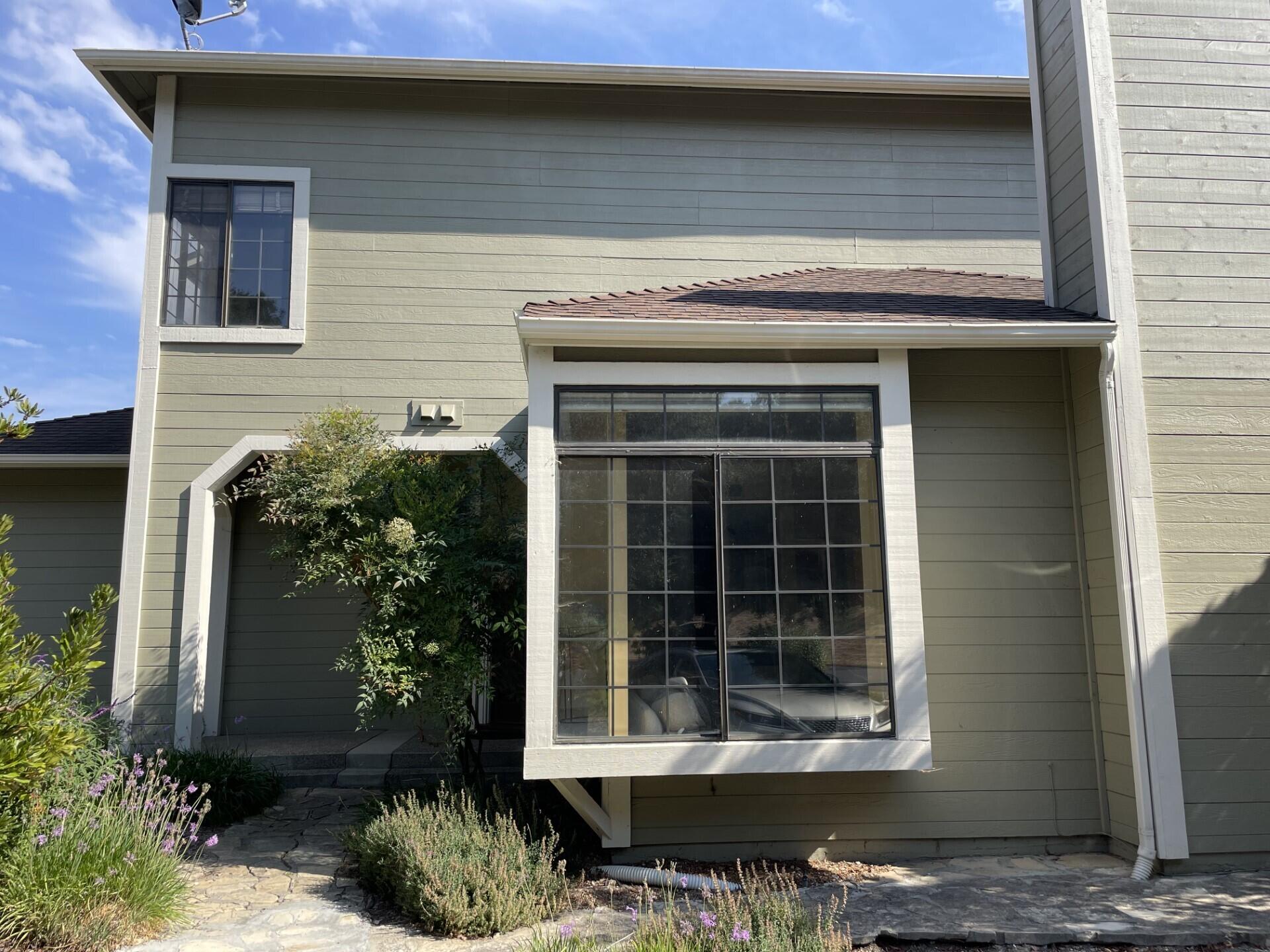 a front view of a house with plants