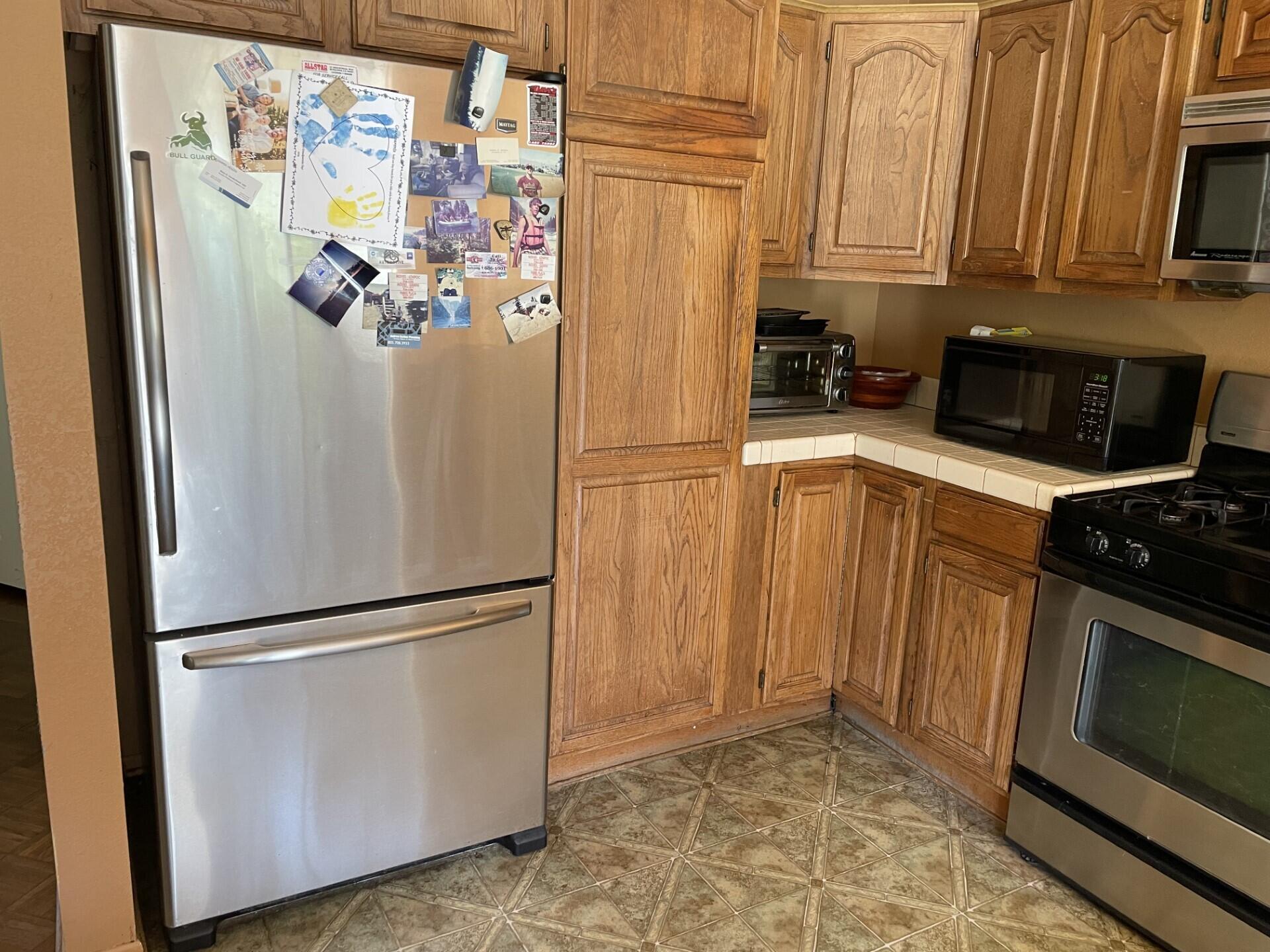 702 Hillside Drive Solvang, CA 93463 - Photo 7 of 15 a white refrigerator freezer and a stove sitting inside of a kitchen