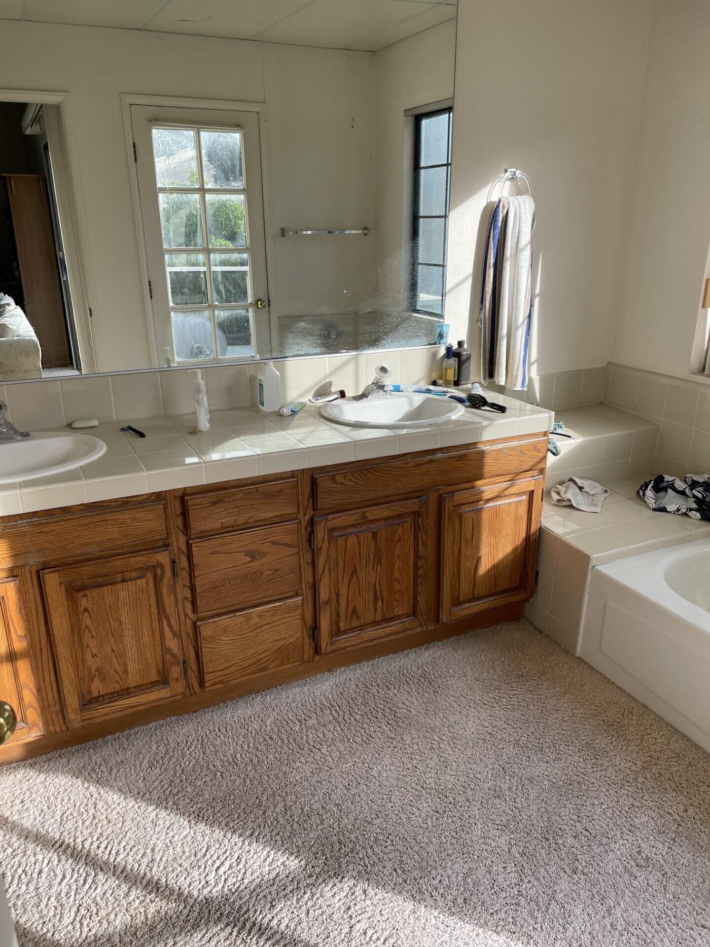 702 Hillside Drive Solvang, CA 93463 - Photo 10 of 15 a bathroom with a tub sink and mirror