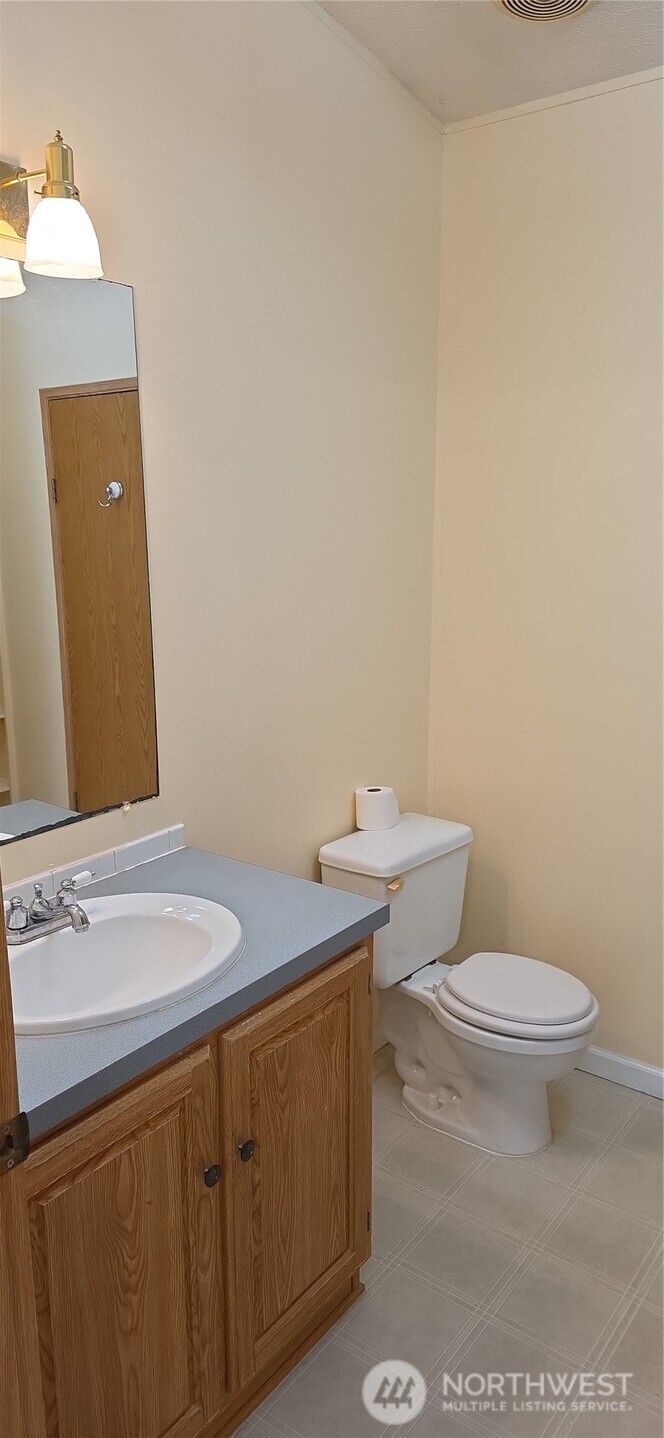 6164 Cedar Lane Maple Falls, WA 98266 - Photo 7 of 15 a bathroom with a sink a toilet and mirror
