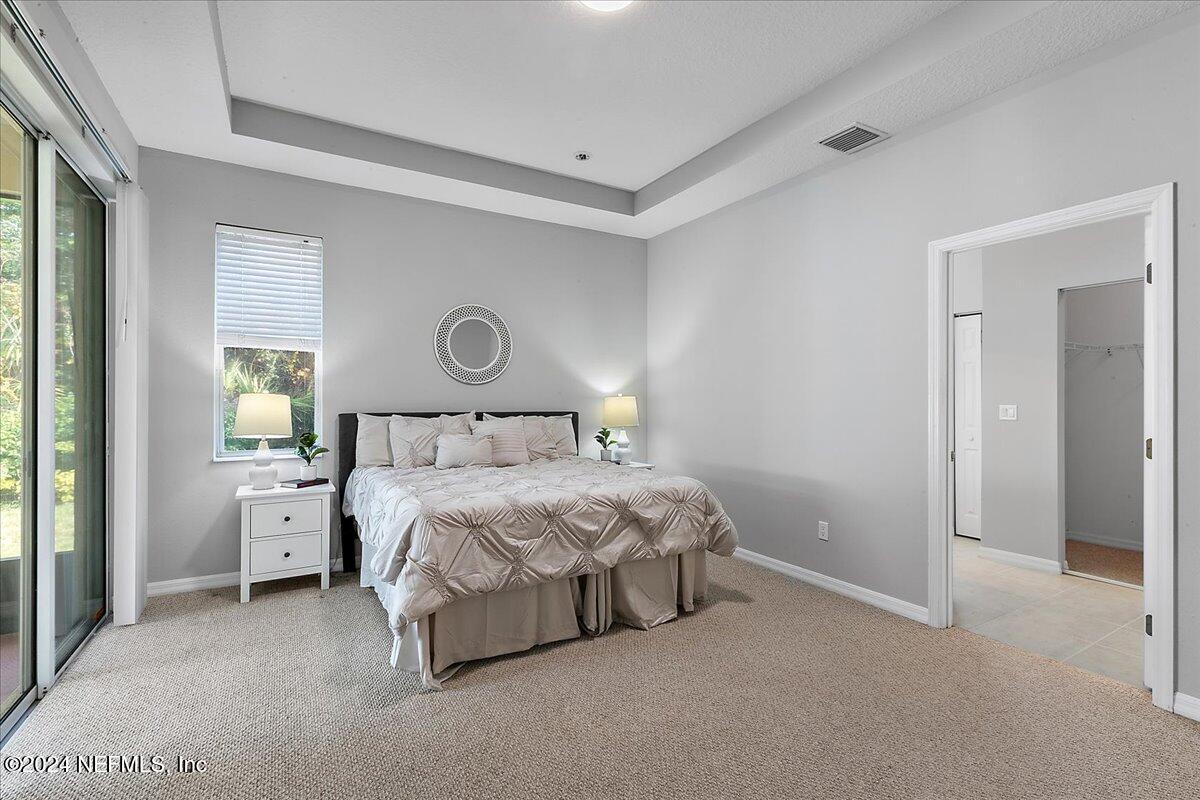 1053 Ridgewood Lane St. Augustine, FL 32086 - Photo 11 of 23 a spacious bedroom with a bed and a lamp