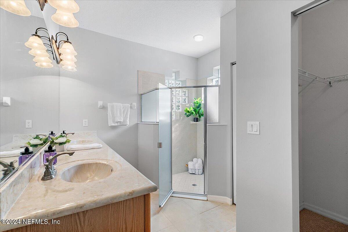 1053 Ridgewood Lane St. Augustine, FL 32086 - Photo 12 of 23 a bathroom with a sink a vanity and mirror
