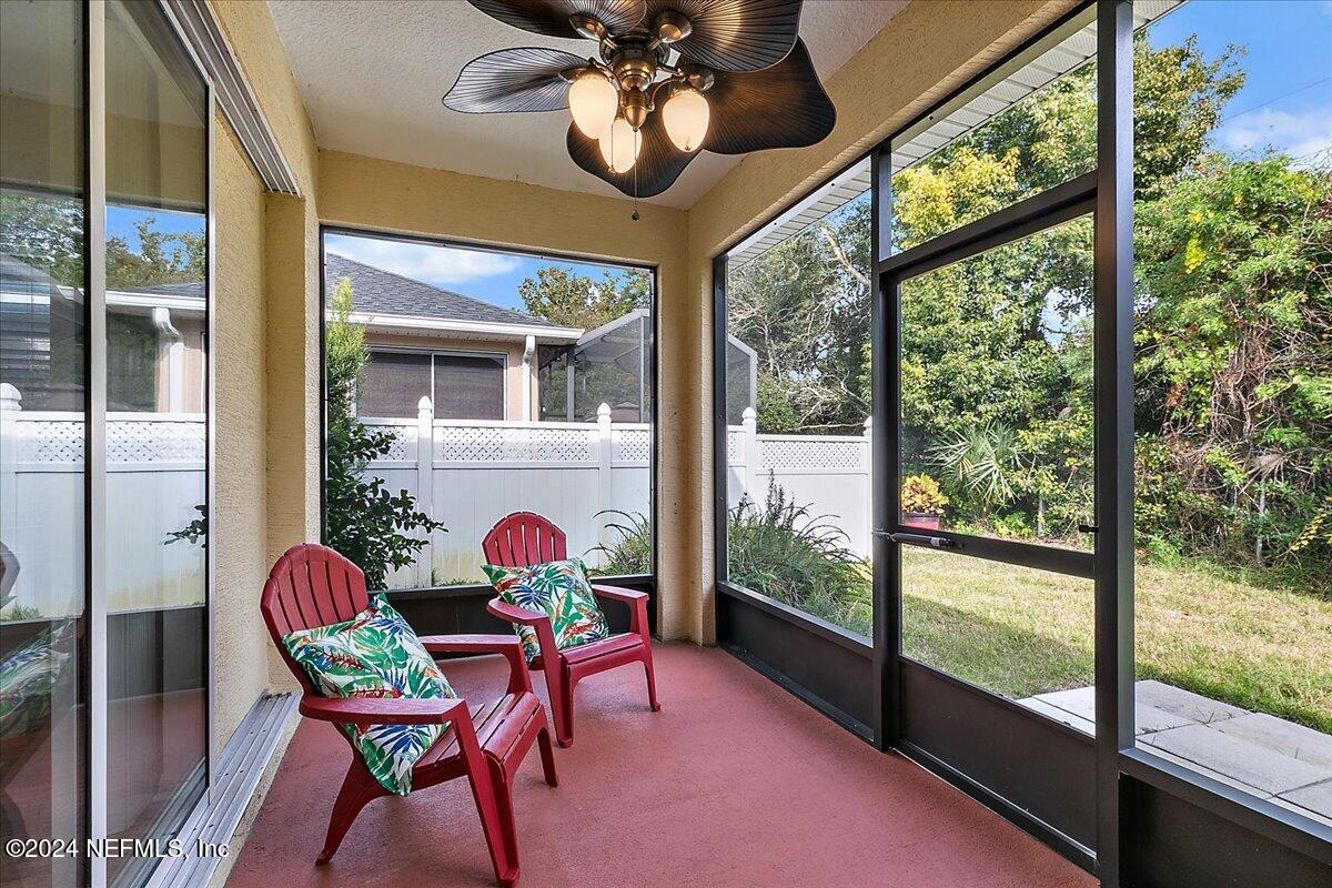 1053 Ridgewood Lane St. Augustine, FL 32086 - Photo 15 of 23 a dining room with wooden floor a chandelier a glass table and chairs
