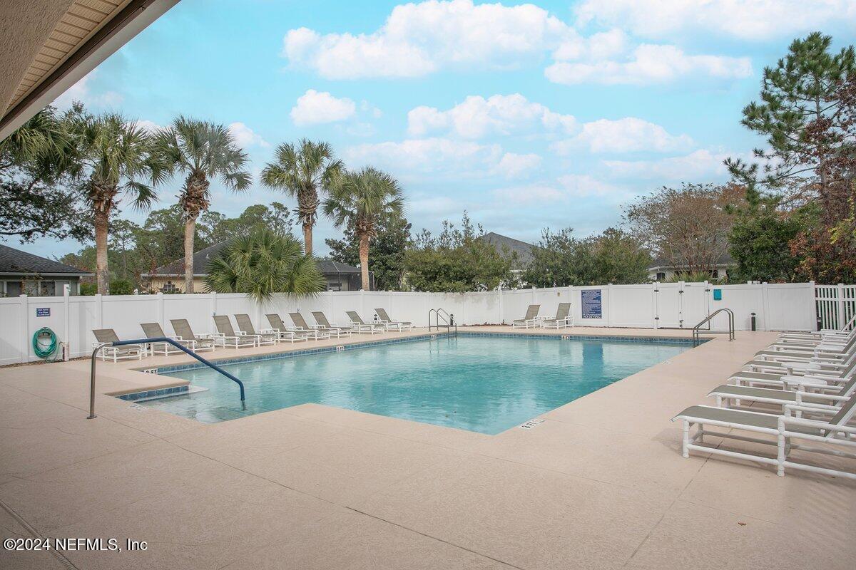 1053 Ridgewood Lane St. Augustine, FL 32086 - Photo 22 of 23 a view of a swimming pool with a patio