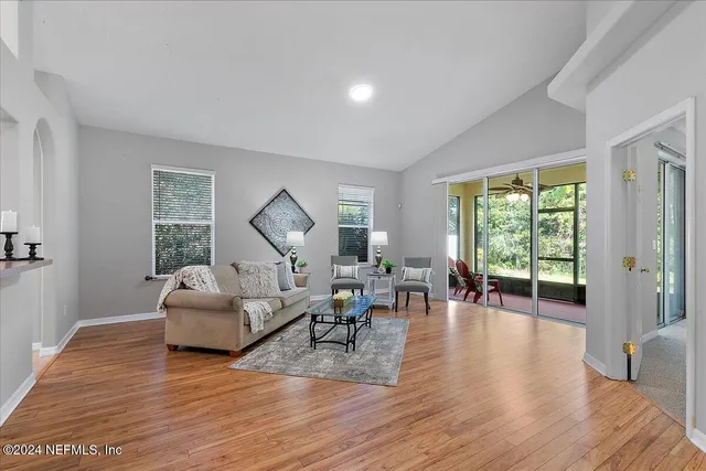 a living room with furniture and a wooden floor