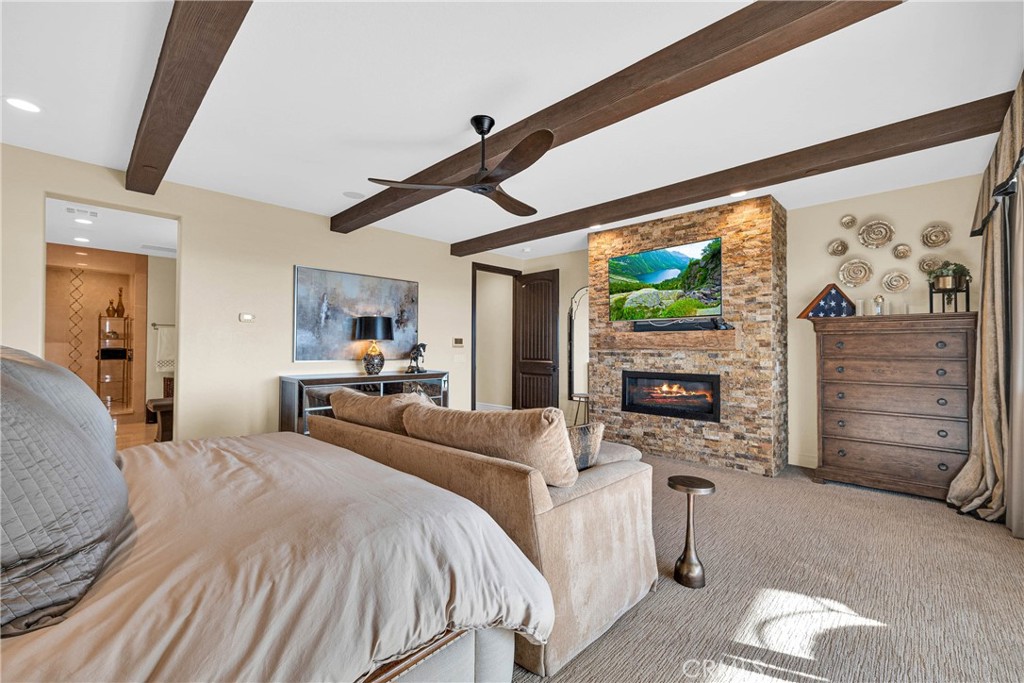 16727 Pienza Court Riverside, CA 92503 - Photo 28 of 41 Primary suite with fireplace, beamed ceiling, and balcony access