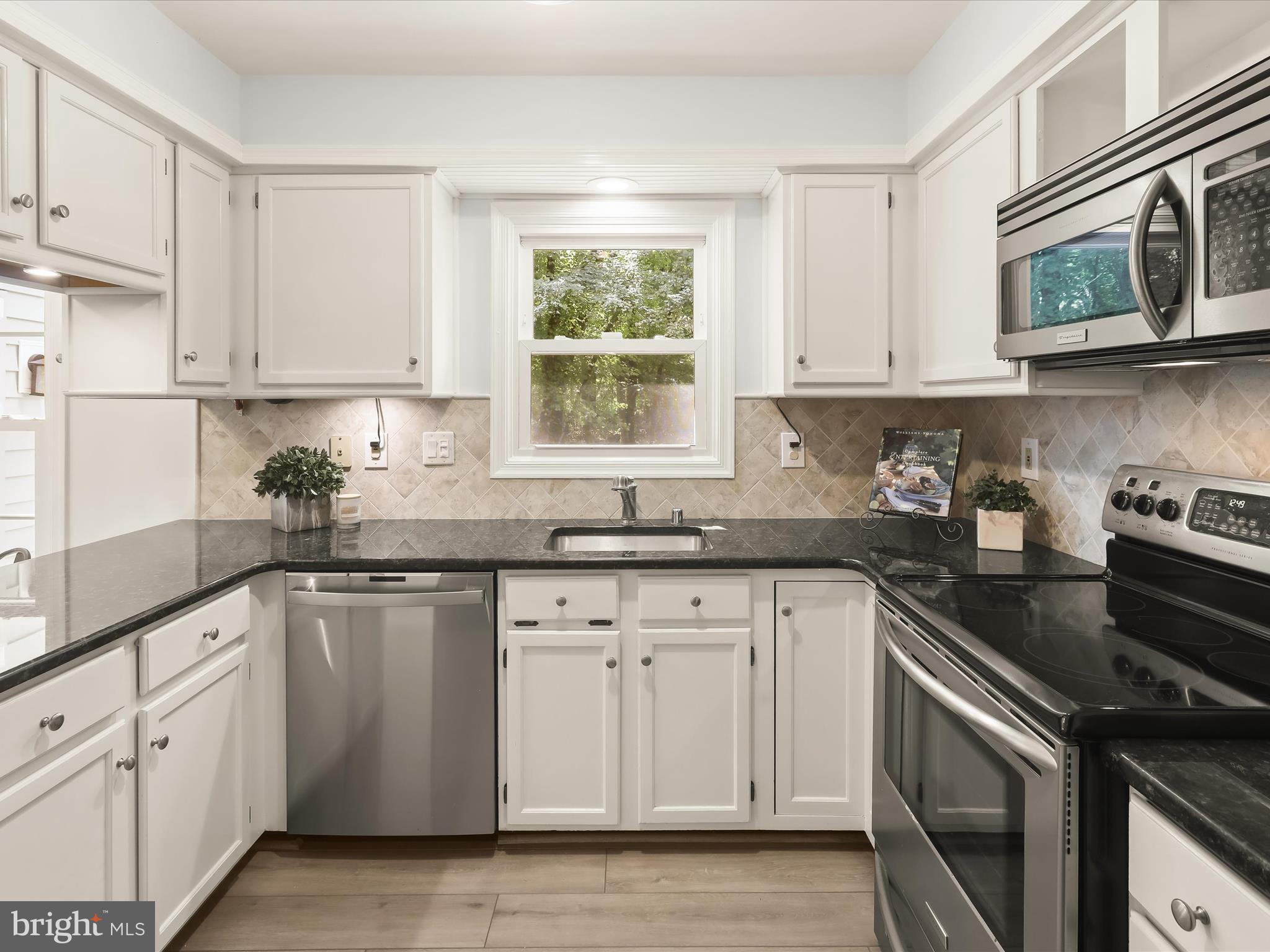 303 Riding Ridge Road Annapolis, MD 21403 - Photo 11 of 43 a kitchen with cabinets appliances a sink and a window