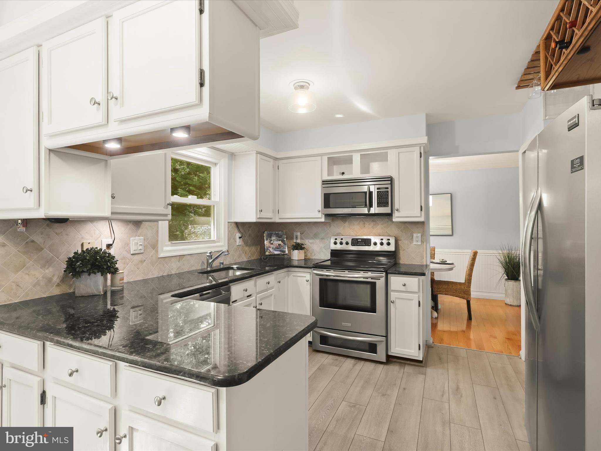 303 Riding Ridge Road Annapolis, MD 21403 - Photo 13 of 43 a kitchen with stainless steel appliances granite countertop a sink a stove and a refrigerator