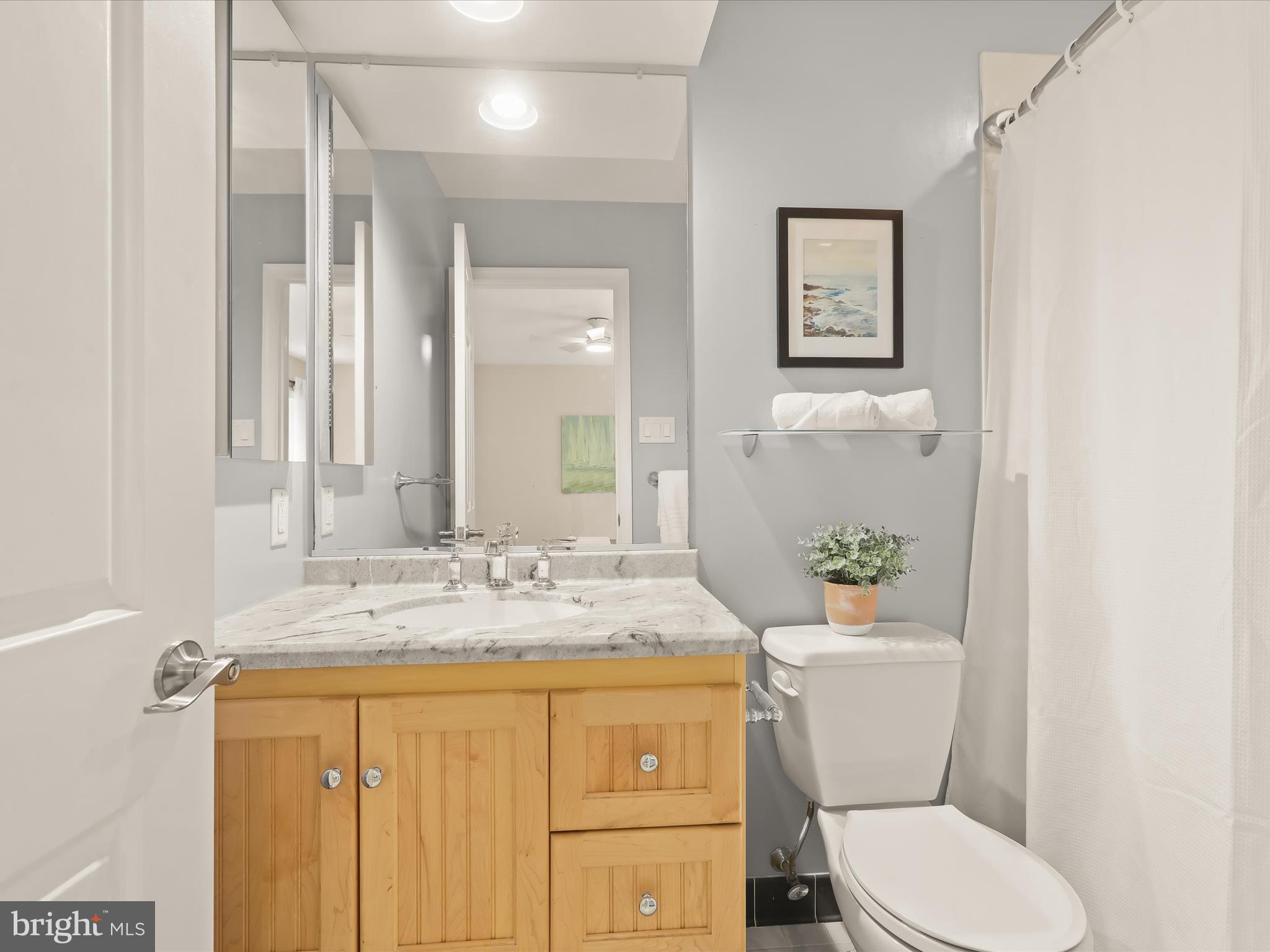 303 Riding Ridge Road Annapolis, MD 21403 - Photo 18 of 43 a bathroom with a granite countertop toilet sink and mirror
