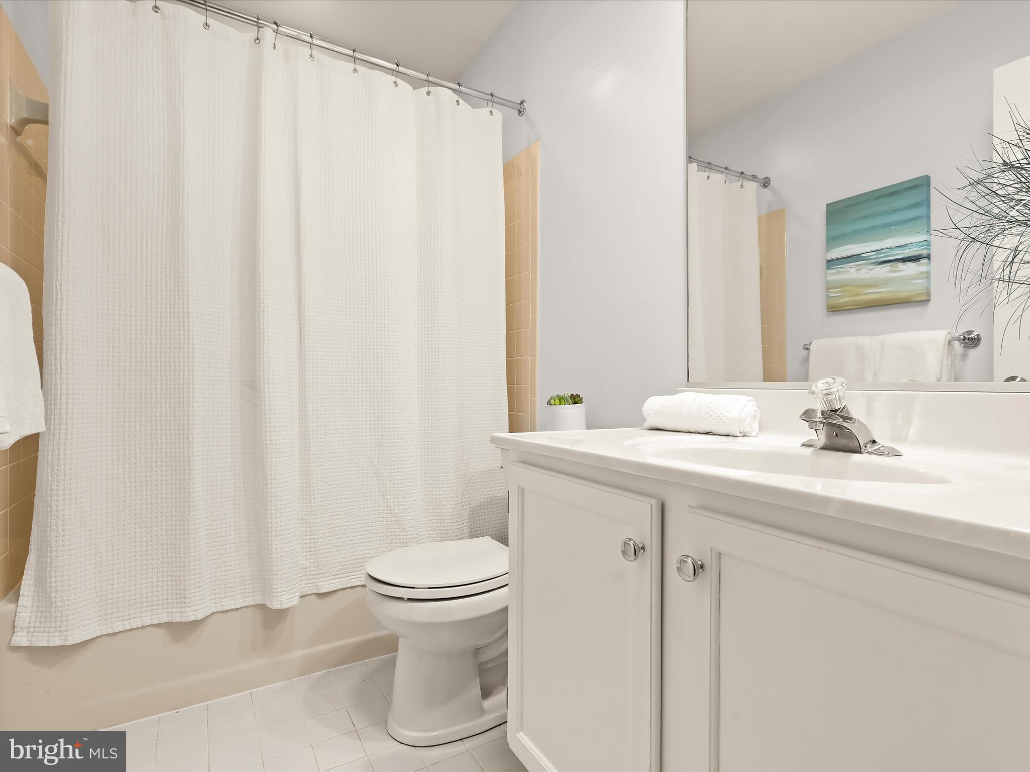 303 Riding Ridge Road Annapolis, MD 21403 - Photo 21 of 43 a bathroom with a sink a toilet and a mirror
