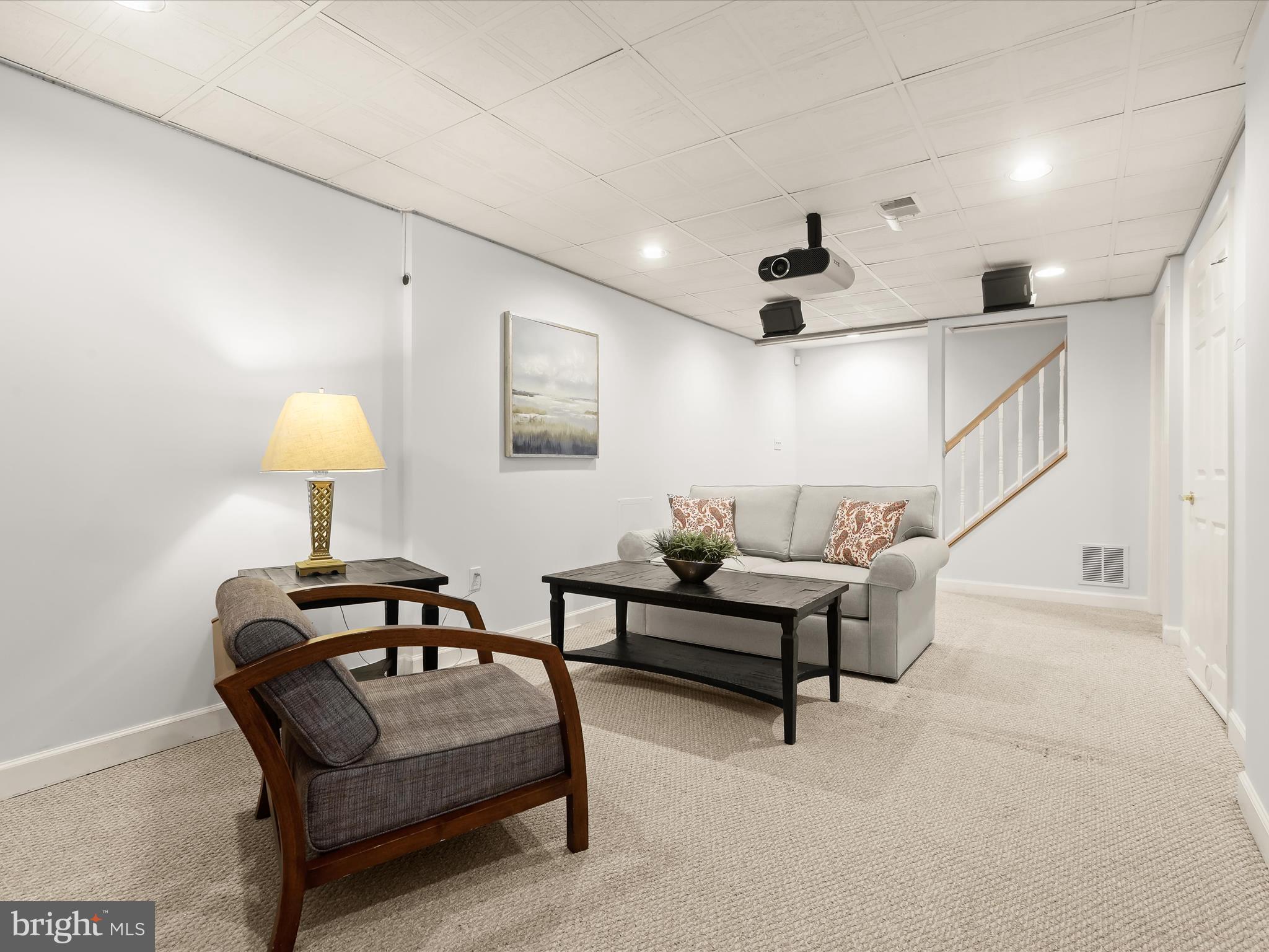303 Riding Ridge Road Annapolis, MD 21403 - Photo 22 of 43 a living room with furniture and a lamp