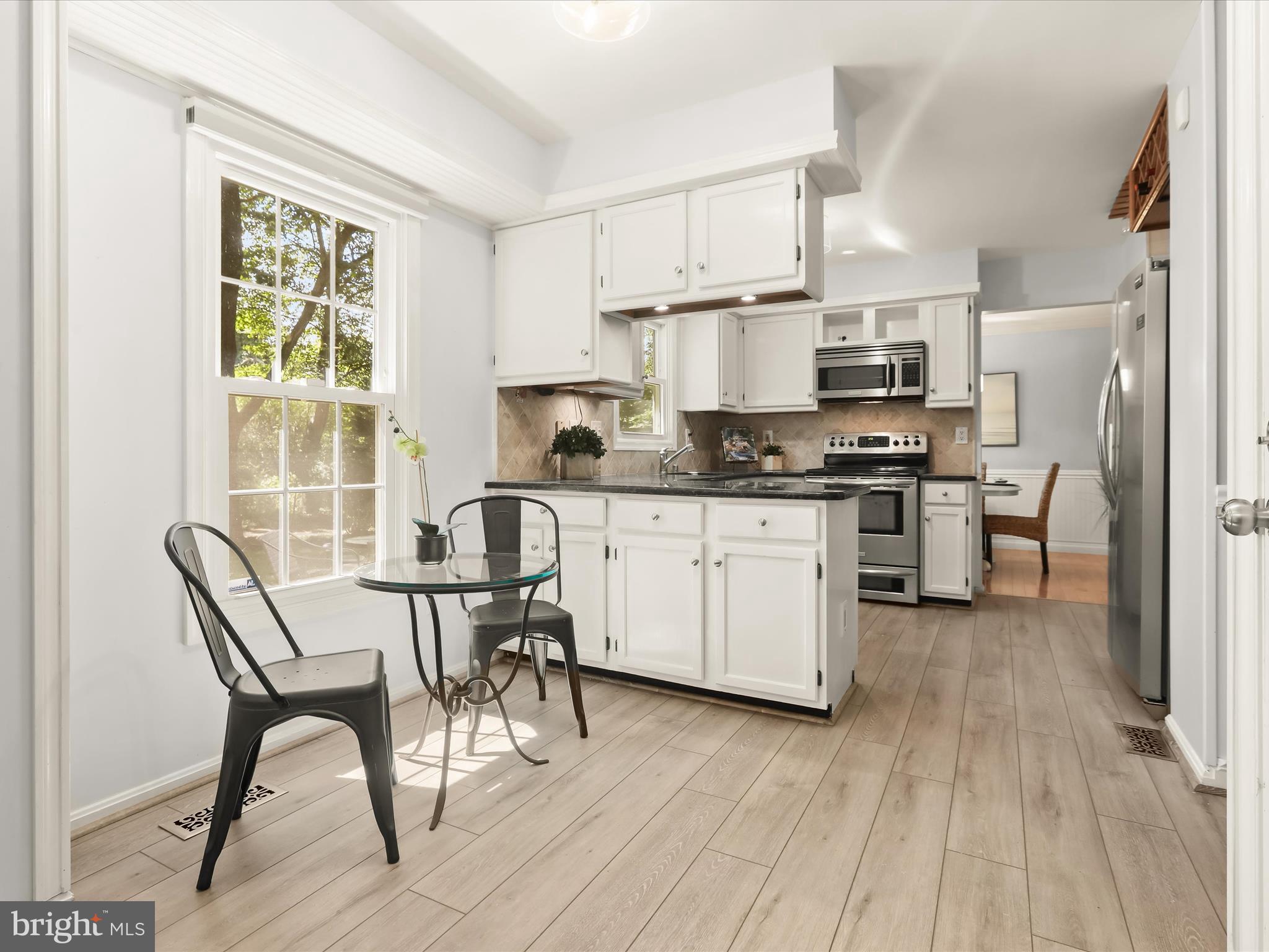 303 Riding Ridge Road Annapolis, MD 21403 - Photo 27 of 43 a kitchen with stainless steel appliances a stove a sink refrigerator and a chair