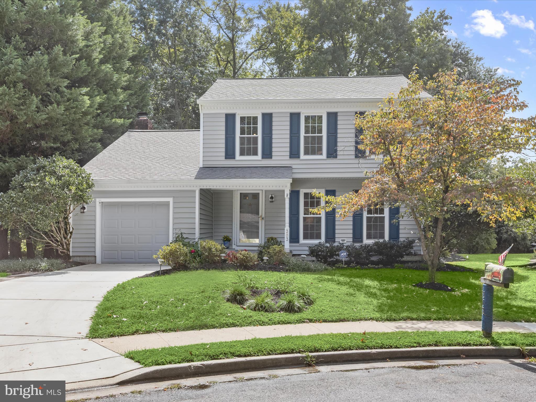 303 Riding Ridge Road Annapolis, MD 21403 - Photo 35 of 43 a front view of a house with a yard and potted plants