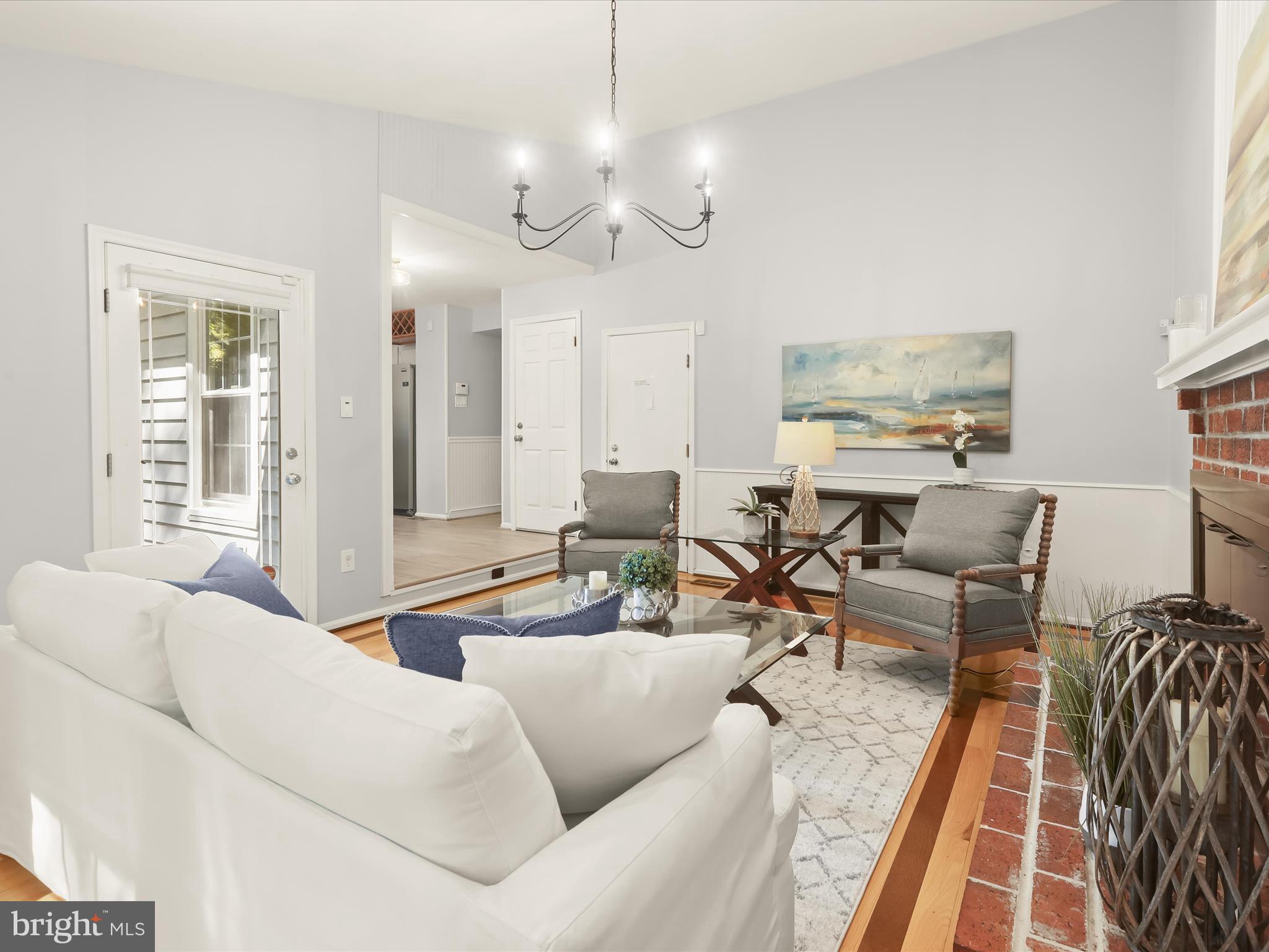 303 Riding Ridge Road Annapolis, MD 21403 - Photo 9 of 43 a living room with furniture a large window and a chandelier