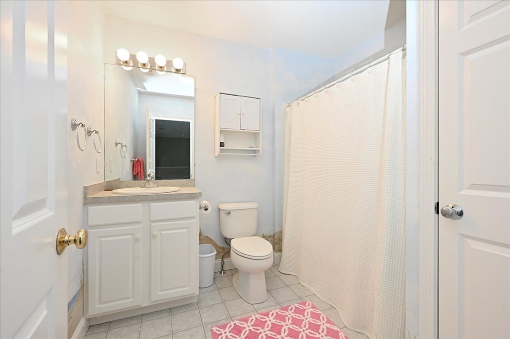 9 Prestwick Road, Unit 9 Bourne, MA 02532 - Photo 17 of 30 a bathroom with a sink a toilet a shower and a mirror