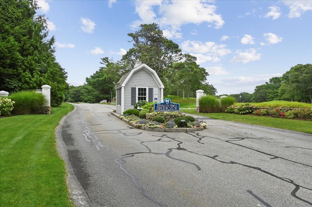 9 Prestwick Road, Unit 9 Bourne, MA 02532 - Photo 28 of 30 a front view of a house with a yard and garage
