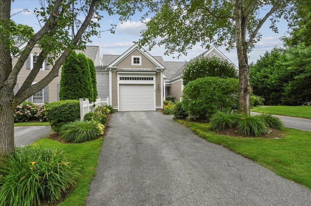 9 Prestwick Road, Unit 9 Bourne, MA 02532 - Photo 3 of 30 a front view of a house with a yard