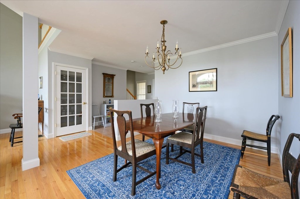 9 Prestwick Road, Unit 9 Bourne, MA 02532 - Photo 6 of 30 a view of a dining room with furniture and wooden floor