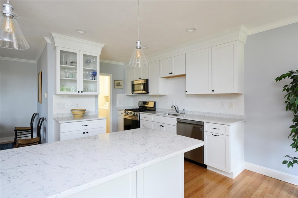 9 Prestwick Road, Unit 9 Bourne, MA 02532 - Photo 8 of 30 a kitchen with granite countertop white cabinets and appliances