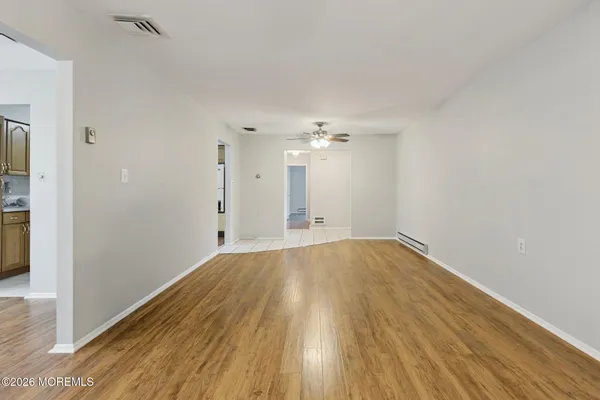 a view of empty room with wooden floor