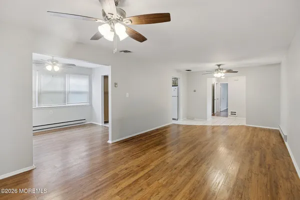 wooden floor in an empty room with a window
