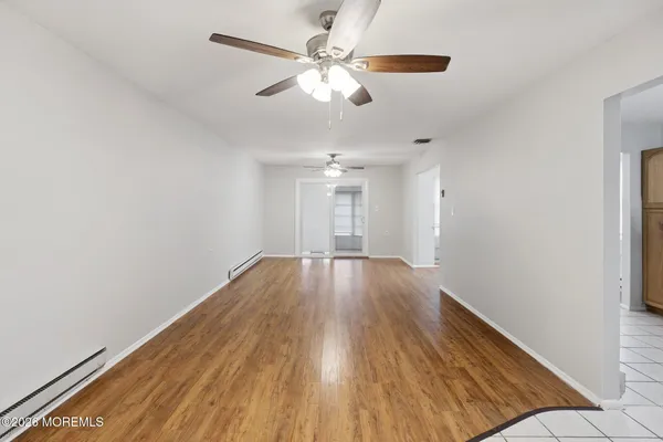wooden floor in an empty room with a window