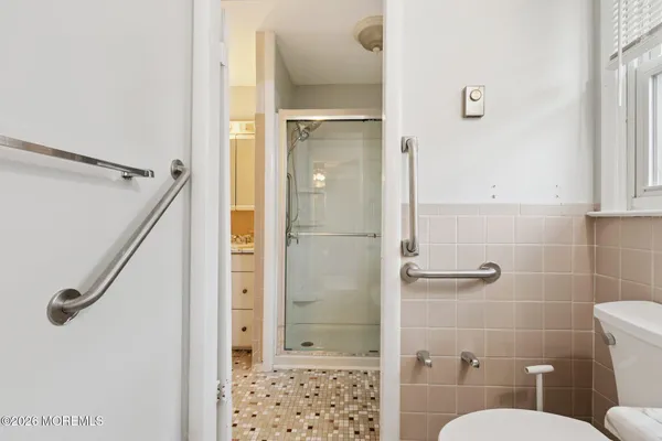 a bathroom with a shower and a toilet