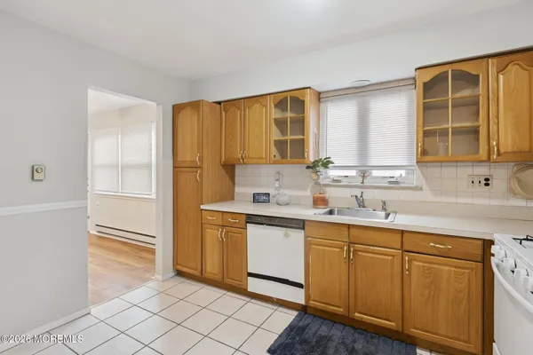 a kitchen with white cabinets and a sink