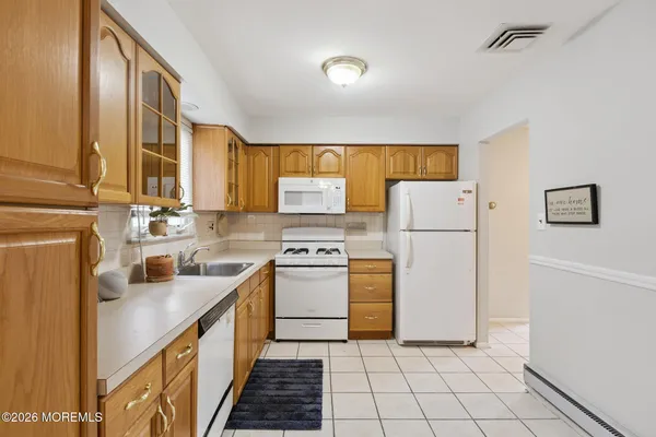 a kitchen with a sink a refrigerator and a stove