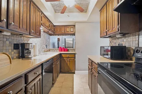 a kitchen with stainless steel appliances granite countertop a sink and cabinets