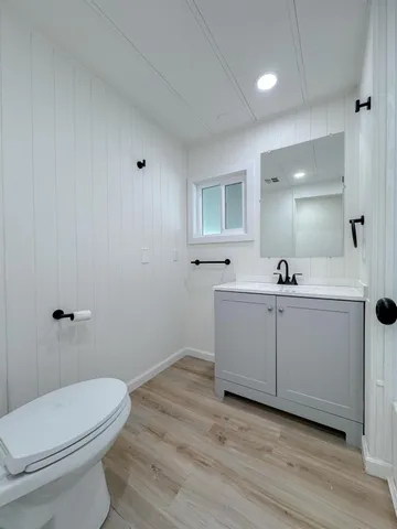 an empty room with wooden floor and a window