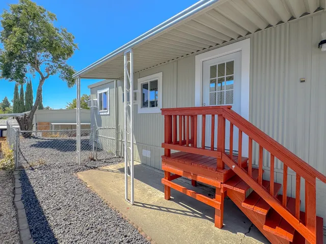 a view of a house with backyard porch and sitting area