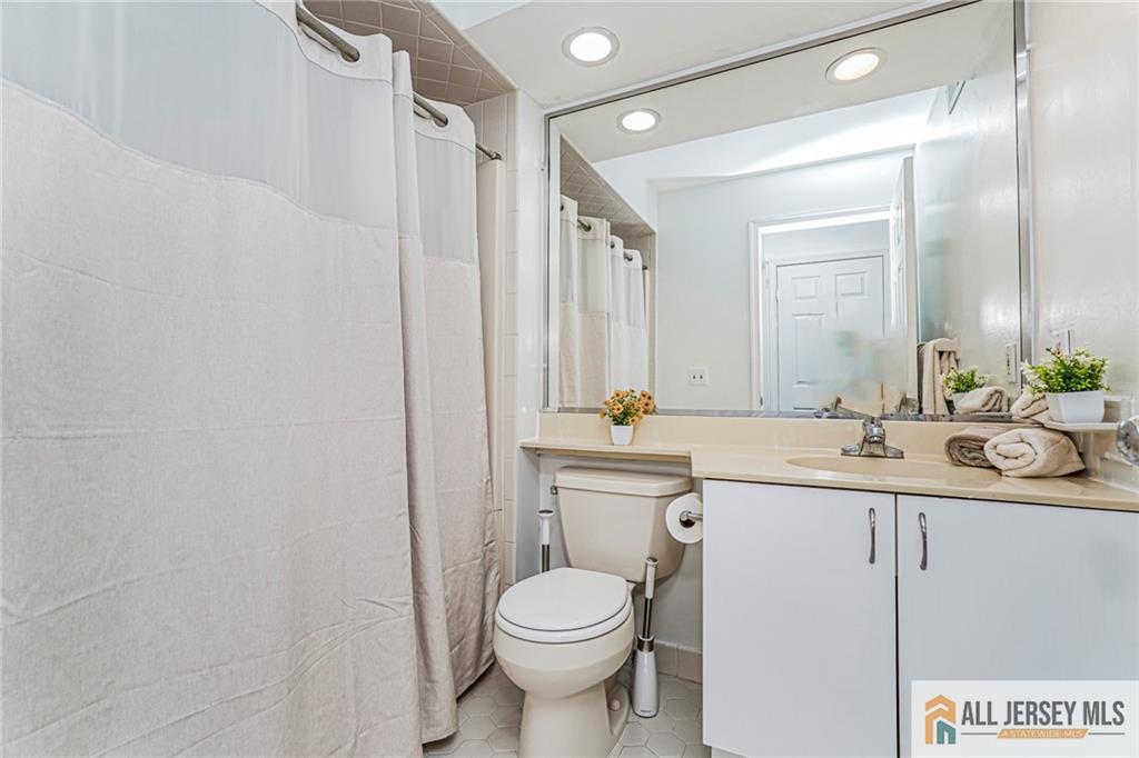 612 Chester Court Helmetta, NJ 08828 - Photo 6 of 31 a bathroom with a toilet sink and mirror