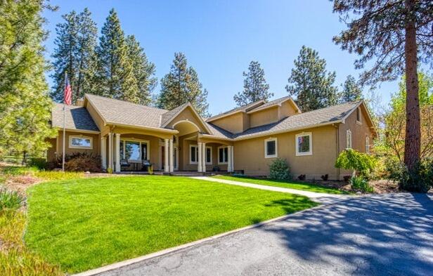 11629 Merganser Road Klamath Falls, OR 97601 - Photo 1 of 50 a front view of a house with a garden and trees