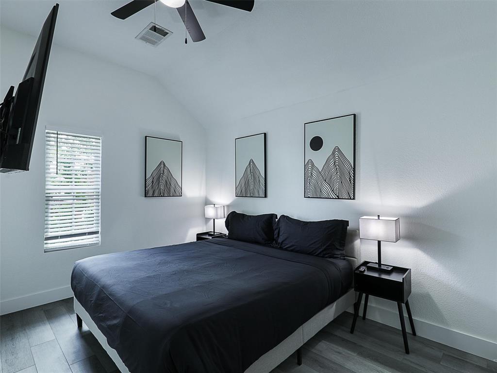 6229 Bear Run Road The Colony, TX 75056 - Photo 11 of 25 a bedroom with a bed and wooden floor