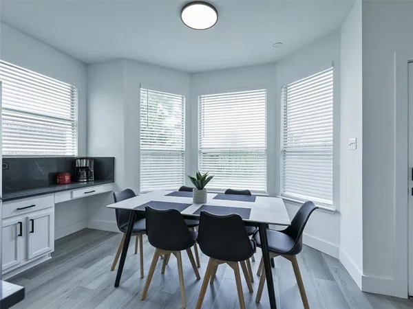 a view of a dining room with furniture and window