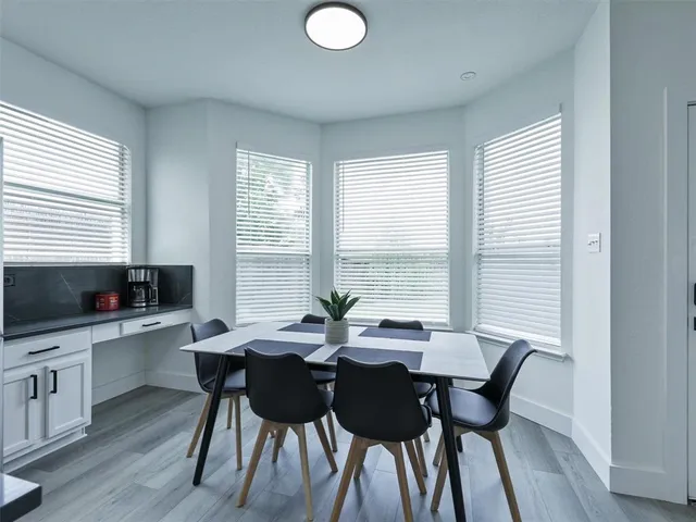 a view of a dining room with furniture and window