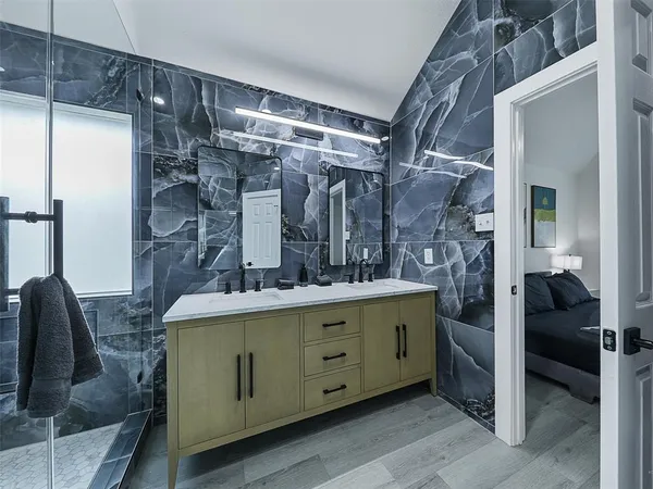 a view of living room kitchen with cabinets and wooden floor