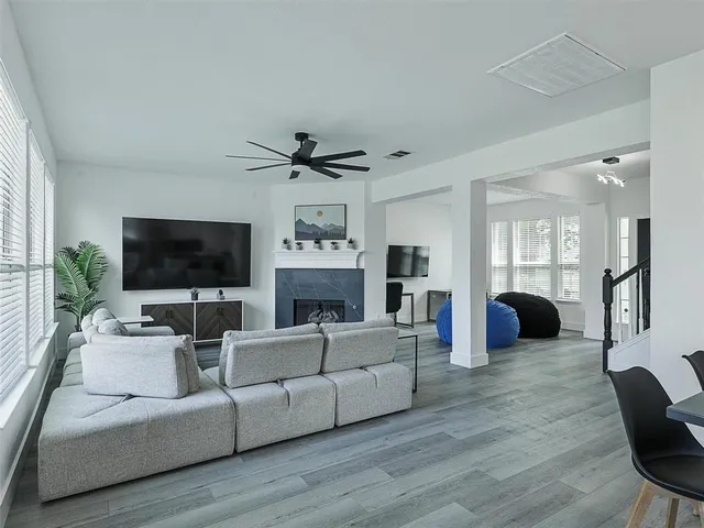 a living room with furniture a flat screen tv and a fireplace