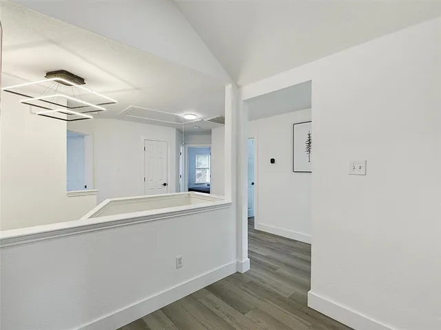 a view of a kitchen with wooden floor