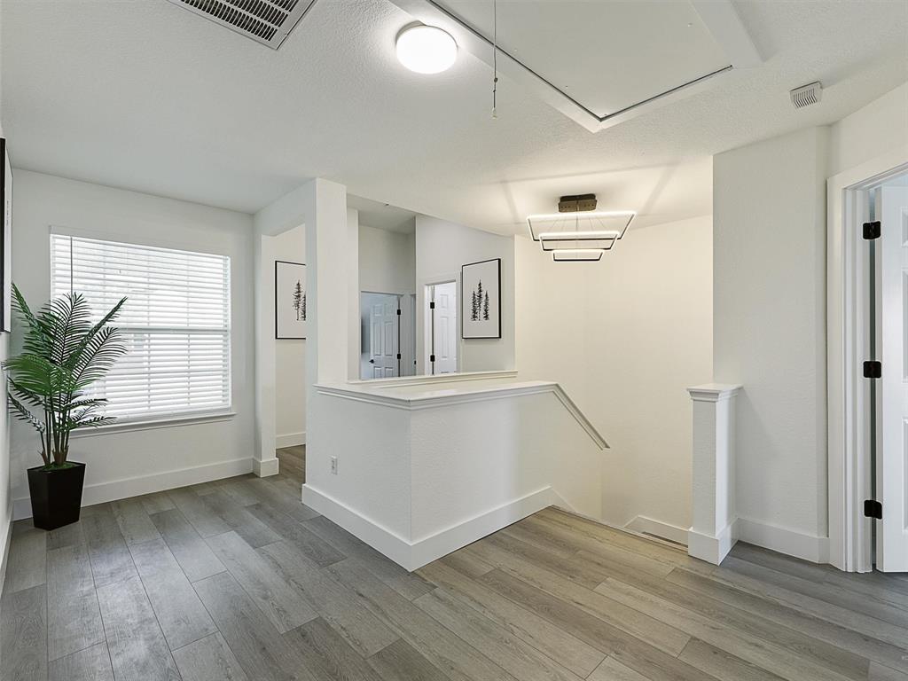 6229 Bear Run Road The Colony, TX 75056 - Photo 6 of 25 an empty room with wooden floor and windows