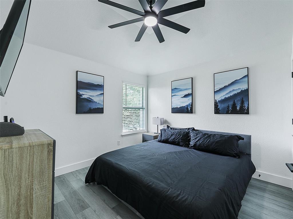 6229 Bear Run Road The Colony, TX 75056 - Photo 9 of 25 a bedroom with a bed and painting on the wall