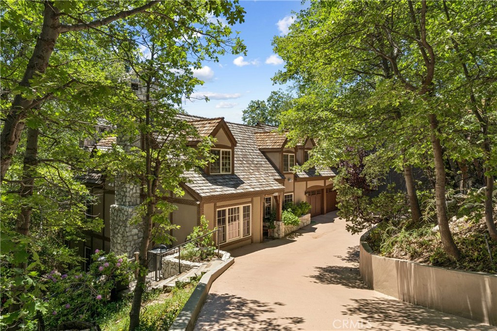 28971 North Shore Road Lake Arrowhead, CA 92352 - Photo 2 of 60 a front view of a house with a yard and large trees