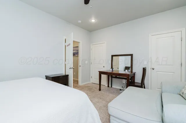 a bedroom with a bed and a table in it