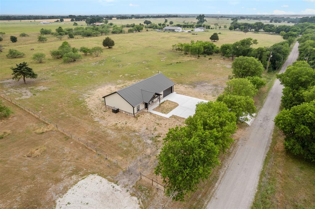 121 Brazier Road Ennis, TX 75119 - Photo 28 of 31 an aerial view of a house with a lake view